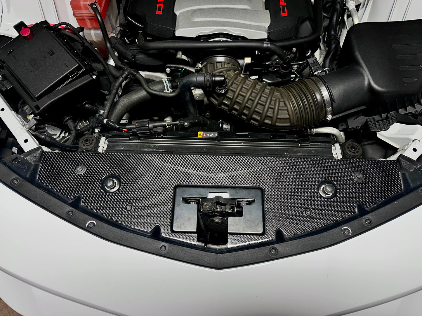 Carbon fiber radiator cover installed on 6th Gen Camaro engine bay