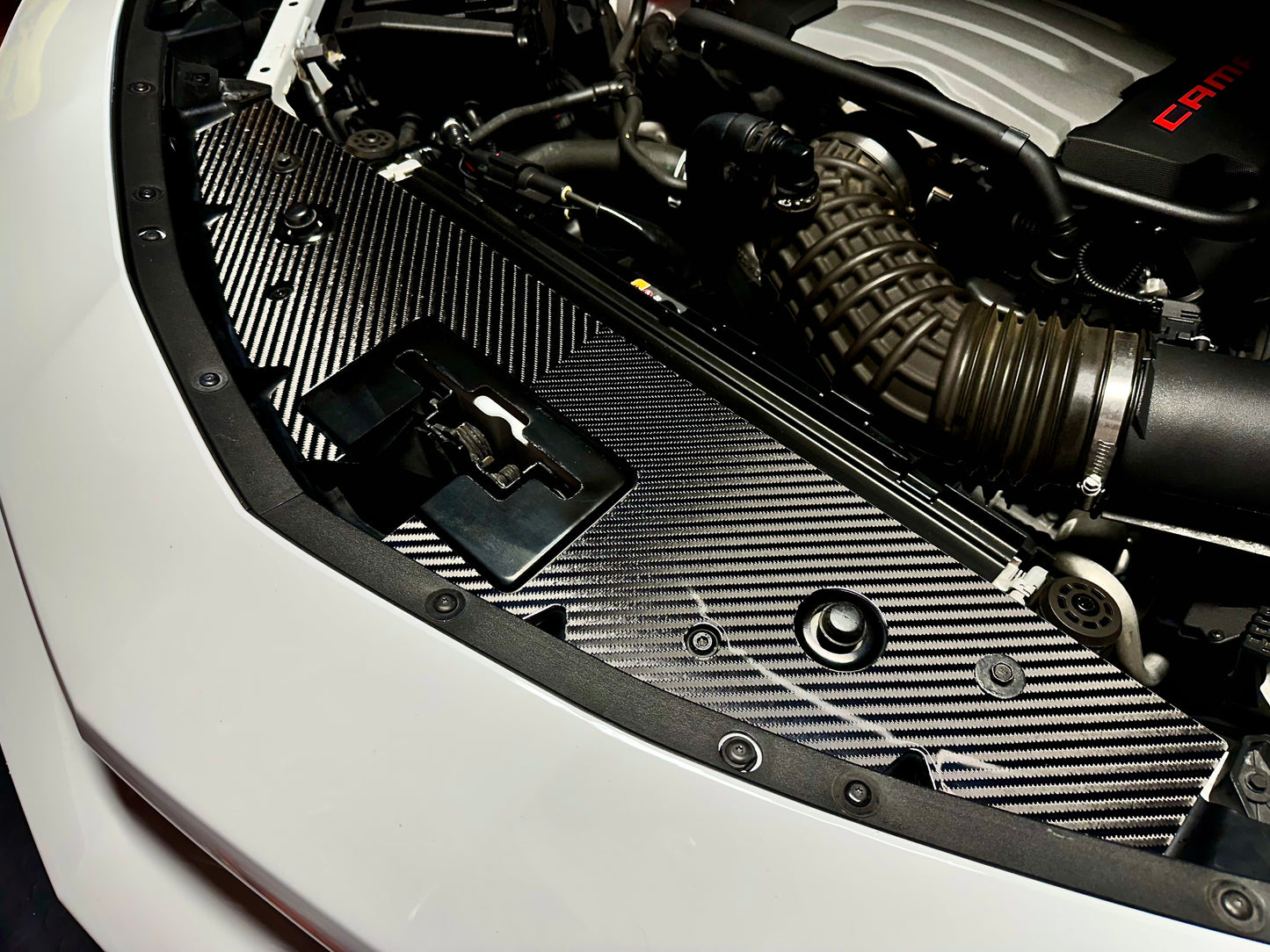 
                  
                    Carbon fiber 4x4 v-twill camaro engine cover installed in engine bay
                  
                