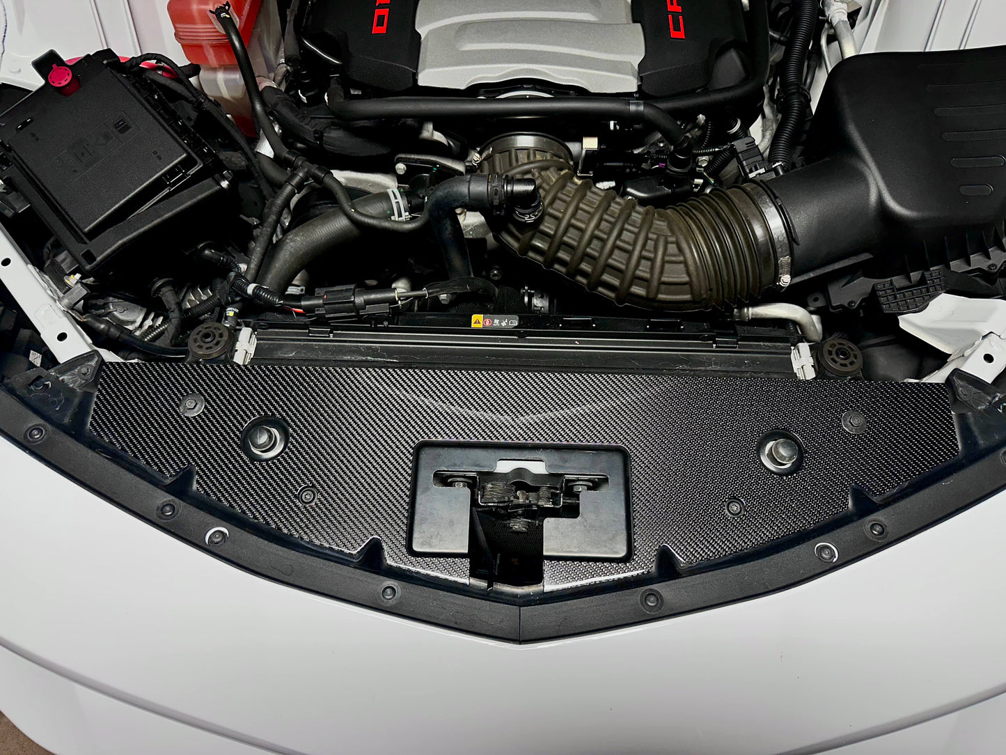 Carbon fiber radiator cover installed on 6th Gen Camaro engine bay