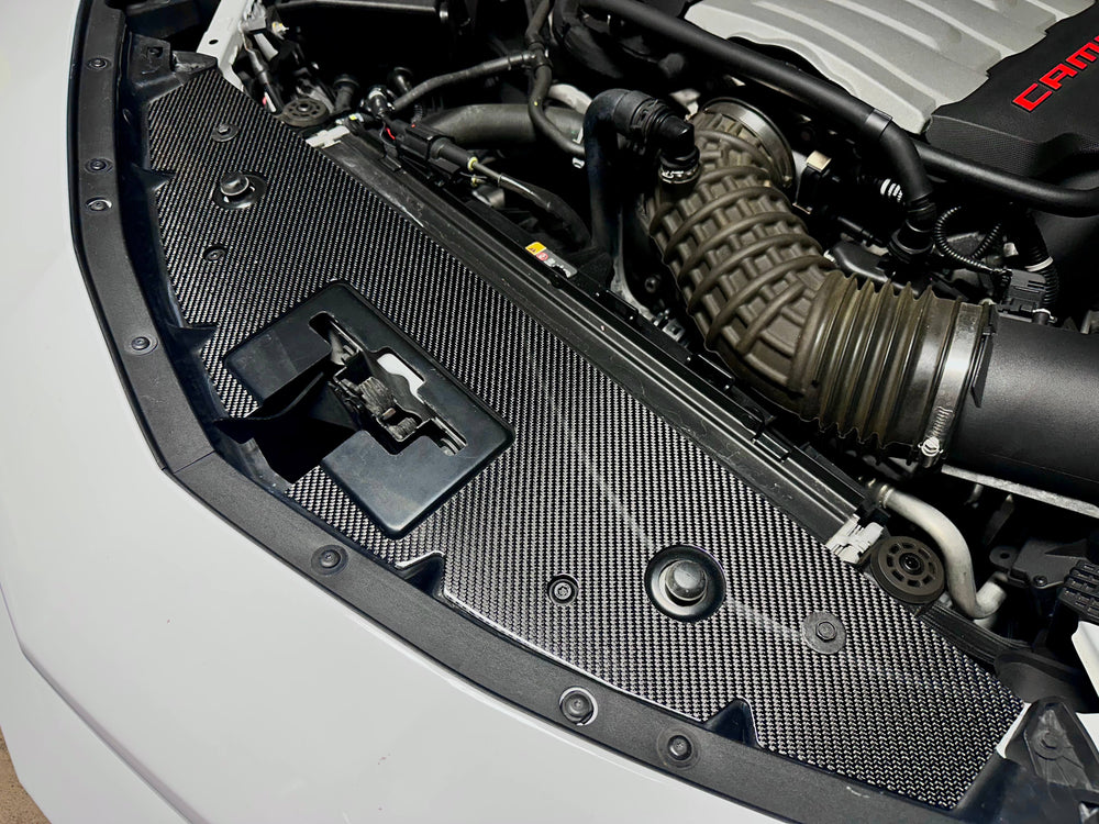 Rebel Carbon Fiber radiator cover installed in engine bay with factory bolts