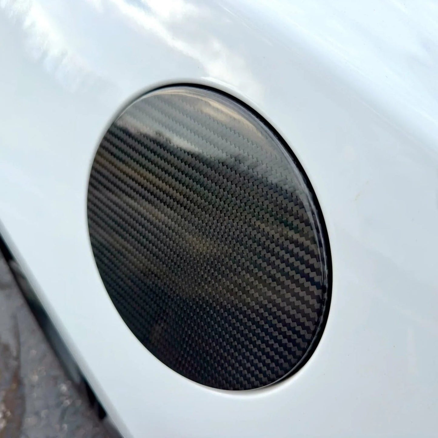 Rebel Carbon Fiber fuel door cover overlay with 2x2 twill weave installed on a white 6th Gen Chevy Camaro