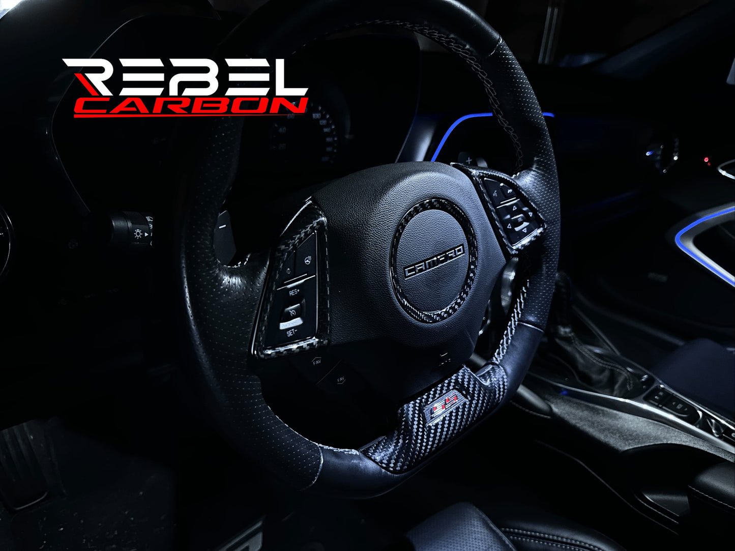 Rebel Carbon Fiber lower steering wheel cover installed on a 6th-Gen Camaro steering wheel with gloss twill weave.
