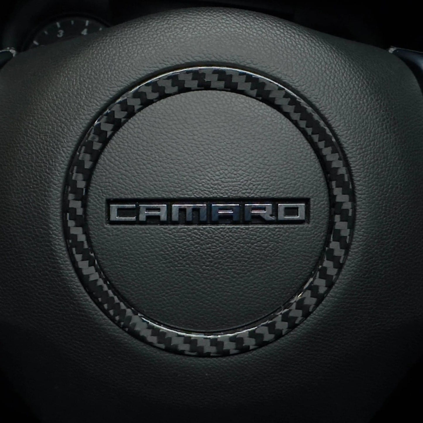 Rebel Carbon Fiber steering wheel center ring cover installed on a 6th Gen Chevrolet Camaro with a glossy finish